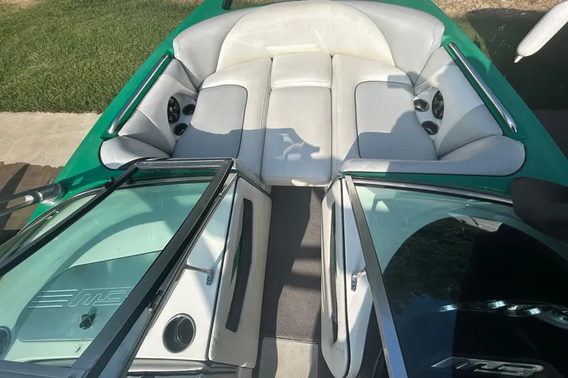 Slide: The Image of 2011 MB F21 Tomcat boat interior with white seating and green accents. - 6