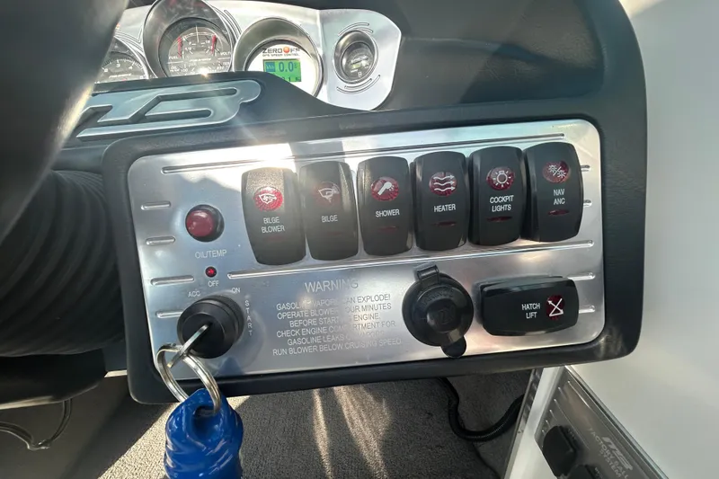 Slide: The Image of Control panel of 2011 MB F21 Tomcat boat with various switches and gauges. - 9