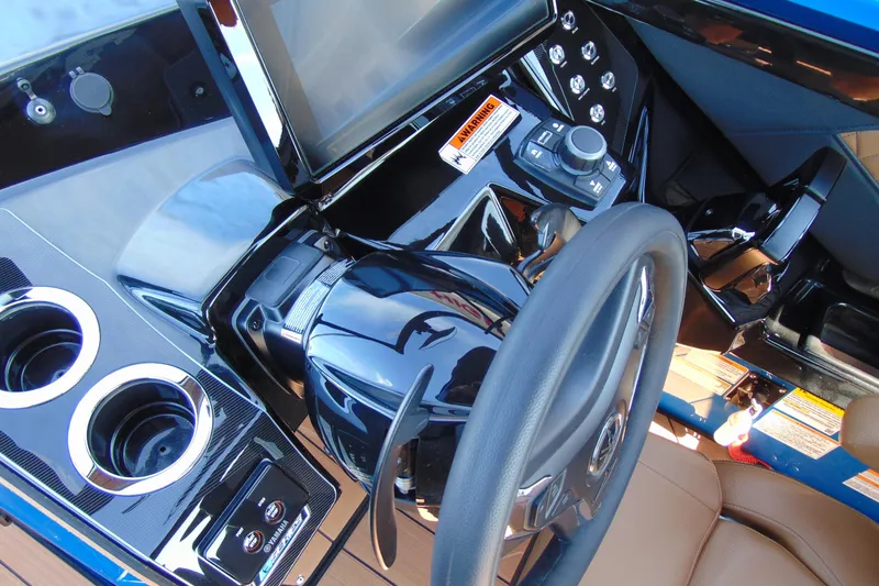 Slide: The Image of 2026 Yamaha Boats 255XD dashboard with steering wheel and controls. - 16