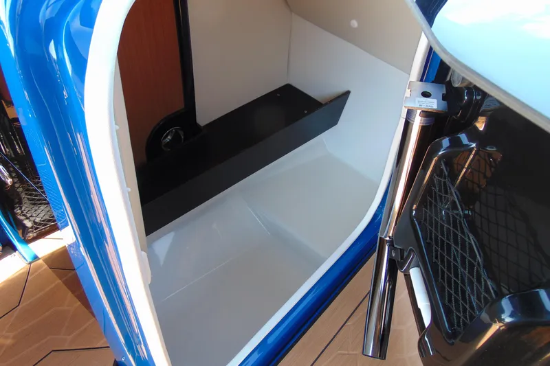 Slide: The Image of Interior storage compartment of 2026 Yamaha Boats 255XD, featuring sleek design and modern finish. - 17