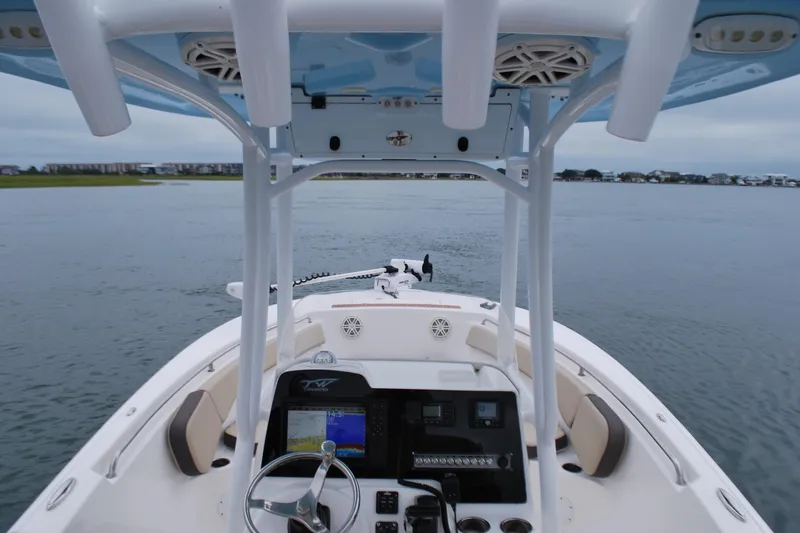 Slide: The Image of 2020 Tidewater 220 LXF boat interior with navigation system on calm water. - 10