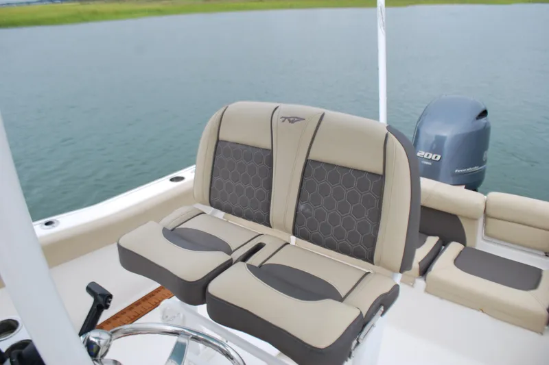 Slide: The Image of 2020 Tidewater 220 LXF boat interior with comfortable seating and outboard motor. - 13