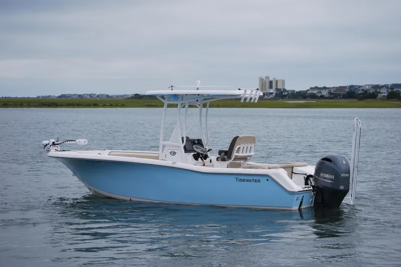 Slide: The Image of 2020 Tidewater 220 LXF boat on calm water with Yamaha outboard motor. - 2