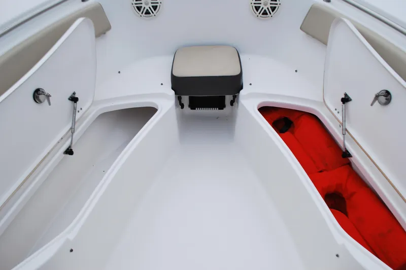 Slide: The Image of 2020 Tidewater 220 LXF boat interior with open storage compartments and seating. - 6
