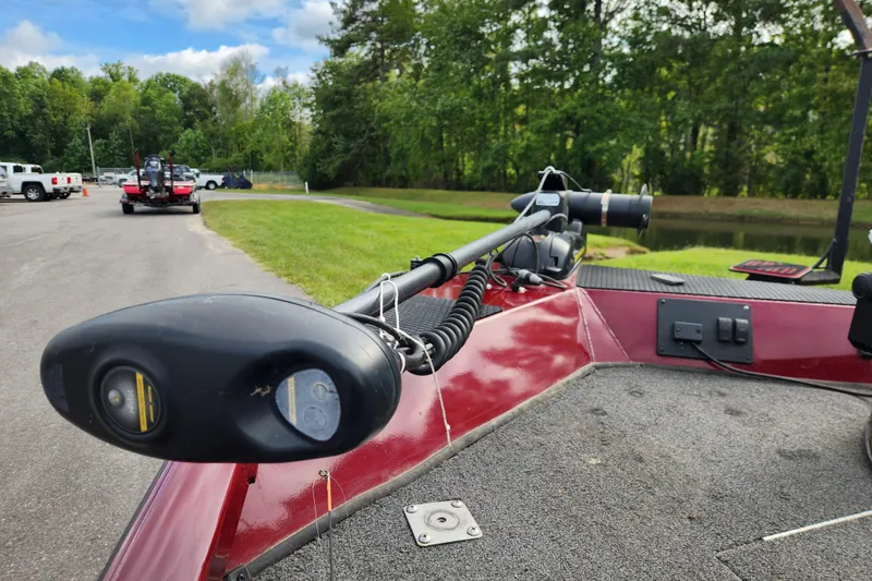 Slide: The Image of 2019 Ranger RT188C boat with trolling motor, parked near a pond and greenery. - 11