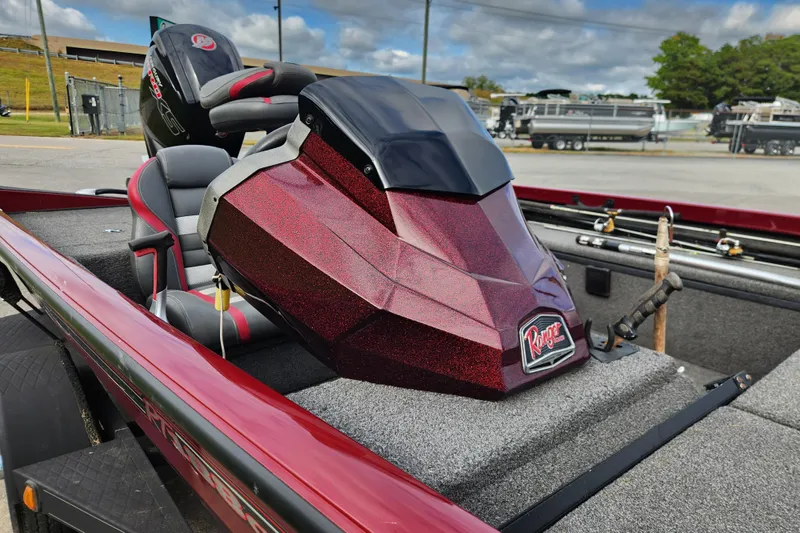 Slide: The Image of 2019 Ranger RT188C boat with red metallic finish, parked outdoors. - 13