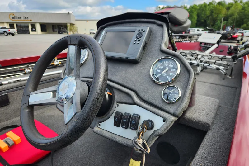 Slide: The Image of 2019 Ranger RT188C boat dashboard with steering wheel, gauges, and control panel. - 14