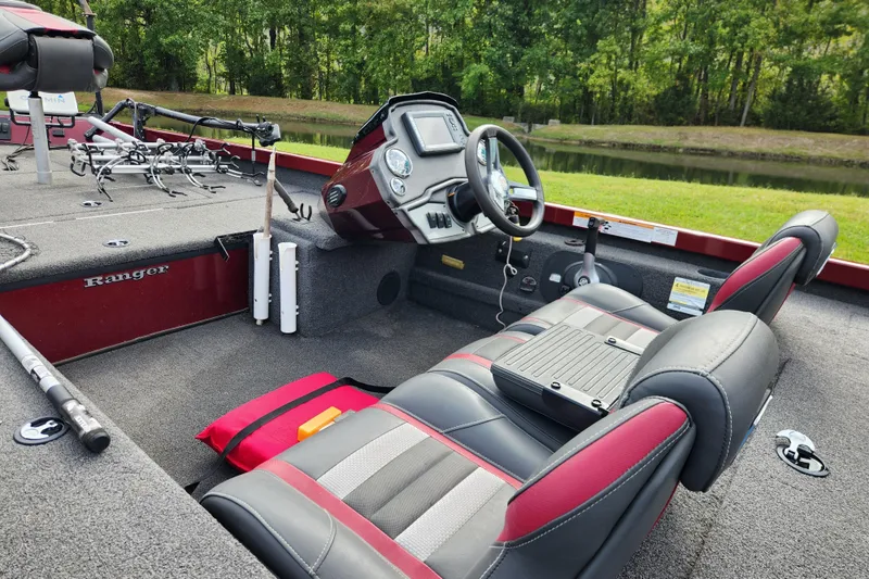 Slide: The Image of 2019 Ranger RT188C boat interior with steering wheel and fishing gear. - 15