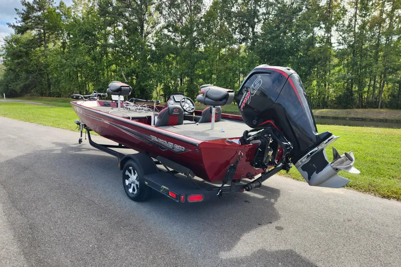 Slide: The Image of 2019 Ranger RT188C boat on trailer, parked on road near lush greenery. - 2