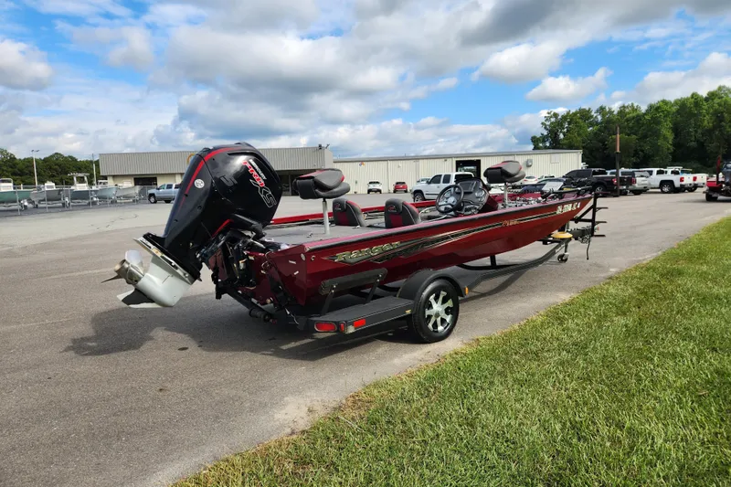 Slide: The Image of 2019 Ranger RT188C boat on trailer, parked outdoors under a cloudy sky. - 5