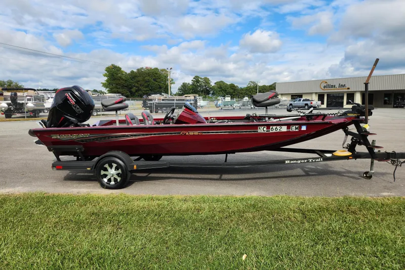 Slide: The Image of 2019 Ranger RT188C boat on trailer, parked outdoors under cloudy sky. - 6