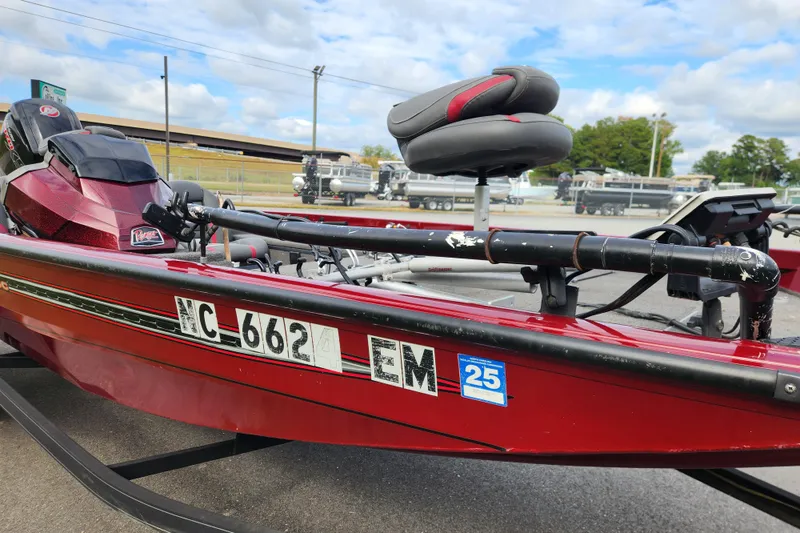 Slide: The Image of 2019 Ranger RT188C red boat with registration number, parked outdoors. - 8