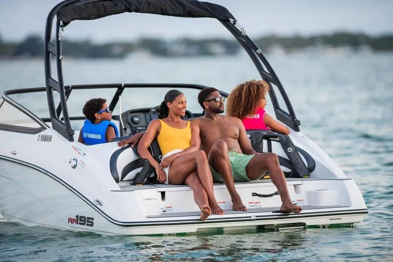 Slide: The Image of Family enjoying a day on a 2025 Yamaha AR195 boat in open water. - 10