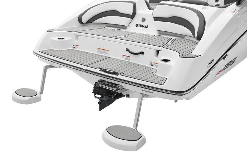 Slide: The Image of 2025 Yamaha Boats AR195 rear view with swim platform and seating. - 2
