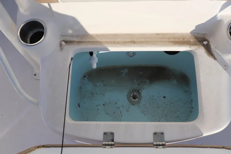 Slide: The Image of Livewell of 2024 Sea Born LX24 Center Console boat, featuring cup holders and drainage. - 5
