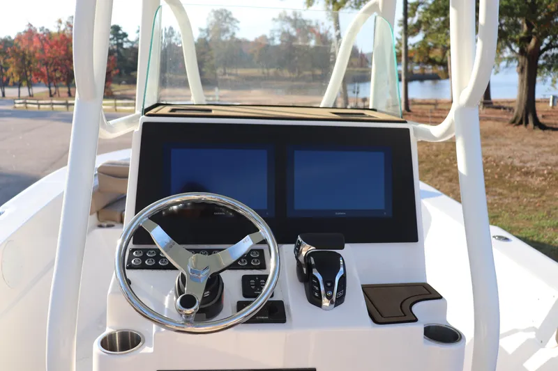 Slide: The Image of 2024 Sea Born LX24 Center Console boat dashboard with dual screens and steering wheel. - 7