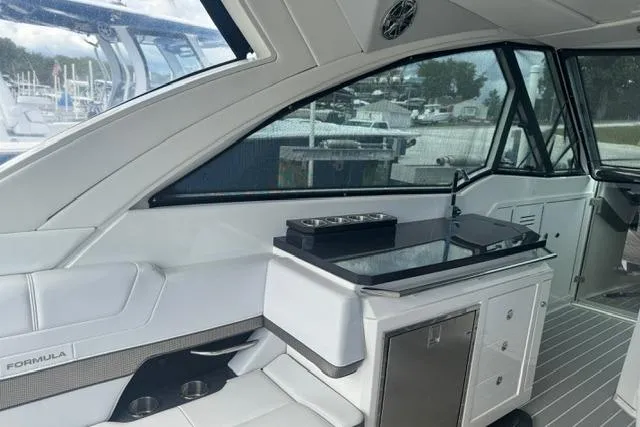Slide: The Image of 2020 Formula 380 Super Sport Crossover I/O interior with seating and kitchenette. - 19