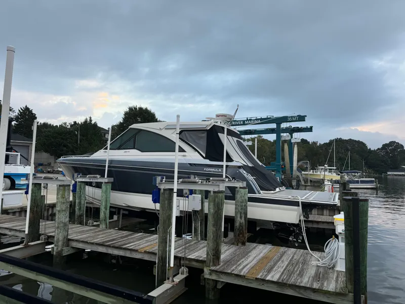 Slide: The Image of 2020 Formula 380 Super Sport Crossover I/O docked at a marina. - 2