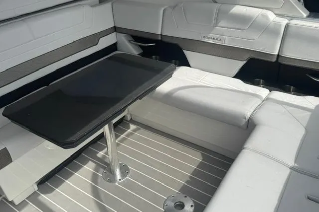 Slide: The Image of 2020 Formula 380 Super Sport Crossover I/O interior with sleek seating and modern table design. - 26