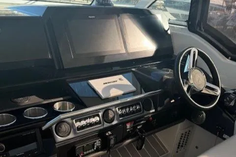 Slide: The Image of 2020 Formula 380 Super Sport Crossover I/O helm with modern controls and displays. - 29