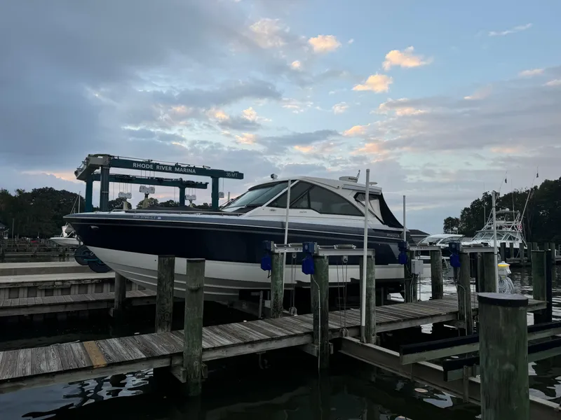 Slide: The Image of 2020 Formula 380 Super Sport Crossover I/O docked at a marina during sunset. - 3