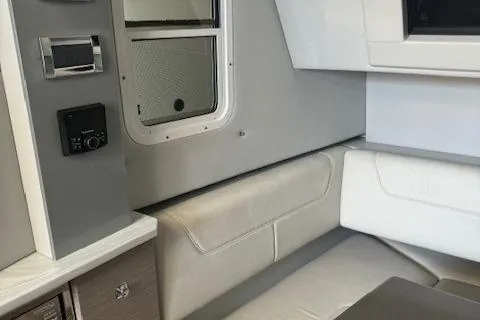 Slide: The Image of Interior of a 2020 Formula 380 Super Sport Crossover I/O boat, featuring seating and control panel. - 40