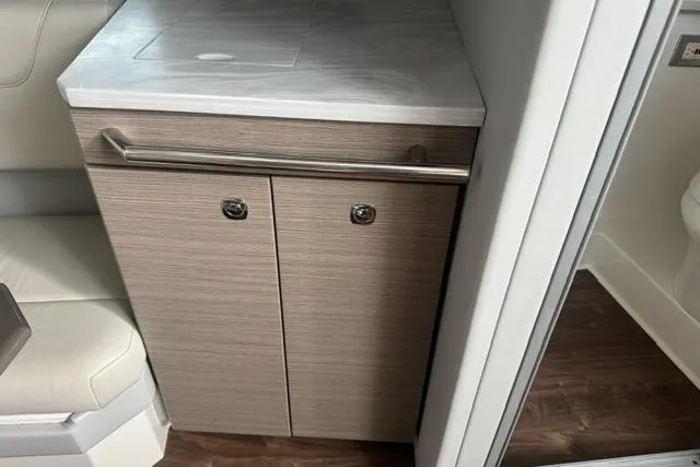 Slide: The Image of 2020 Formula 380 Super Sport Crossover I/O interior cabinet with sleek wood finish and countertop. - 48