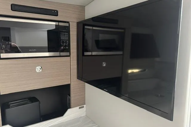 Slide: The Image of Interior of 2020 Formula 380 Super Sport Crossover with modern appliances and flat-screen TV. - 49