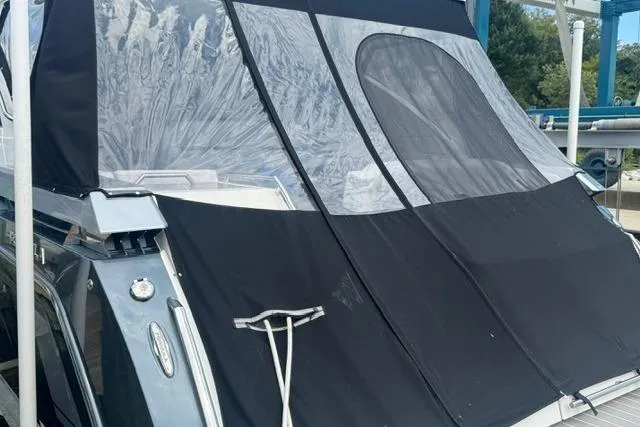 Slide: The Image of 2020 Formula 380 Super Sport Crossover I/O with protective cover at a marina. - 9