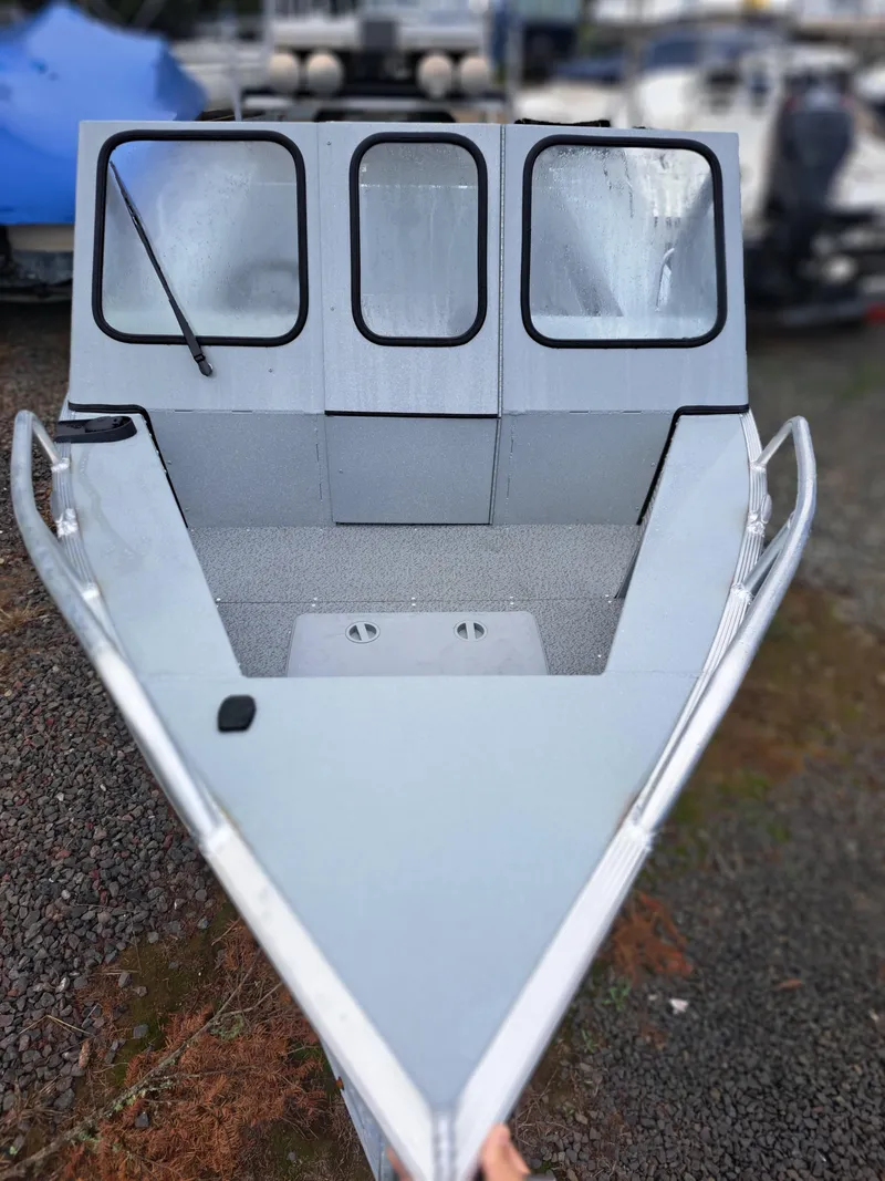 Slide: The Image of 2025 Klamath 19 GTX boat with windshield, parked on gravel. - 4