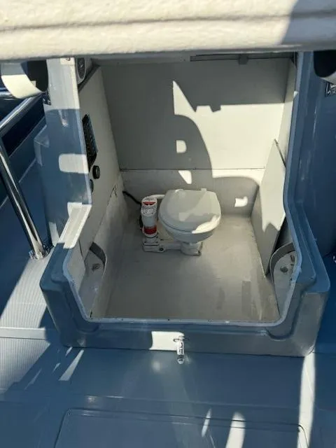 Slide: The Image of 2022 Allmand 31 RIB boat interior with compact marine toilet. - 7
