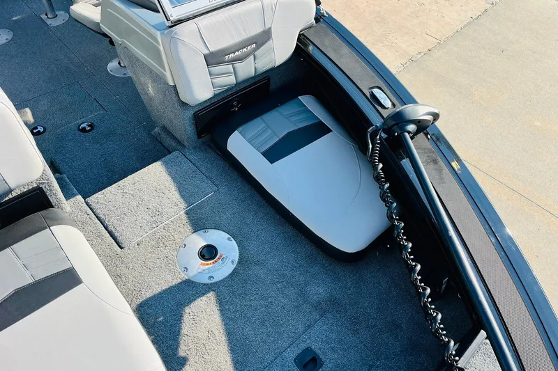 Slide: The Image of 2018 Tracker Targa V-19 Combo boat interior with gray seating and carpeted flooring. - 16