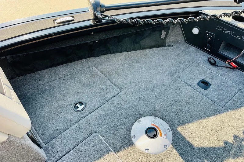 Slide: The Image of 2018 Tracker Targa V-19 Combo 40th Anniversary Edition boat interior with carpeted deck. - 17