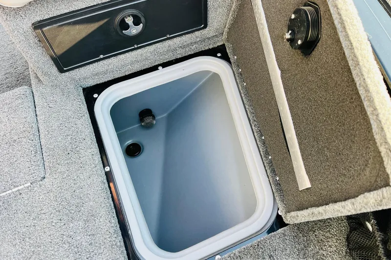 Slide: The Image of 2018 Tracker Targa V-19 Combo livewell compartment, open with gray interior. - 19