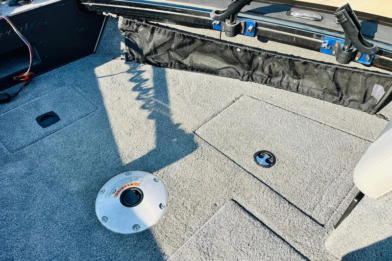 Slide: The Image of 2018 Tracker Targa V-19 Combo boat interior with carpeted deck and storage compartments. - 21