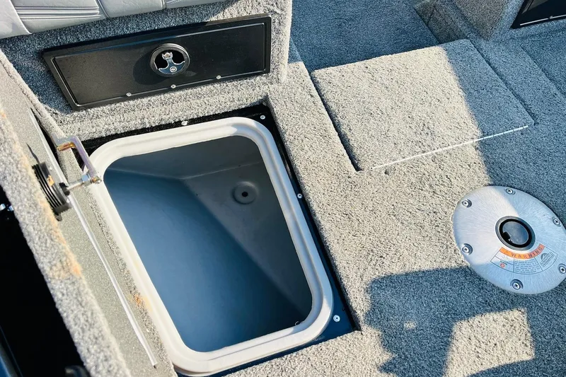 Slide: The Image of 2018 Tracker Targa V-19 Combo storage compartment with carpeted interior and secure latch. - 23