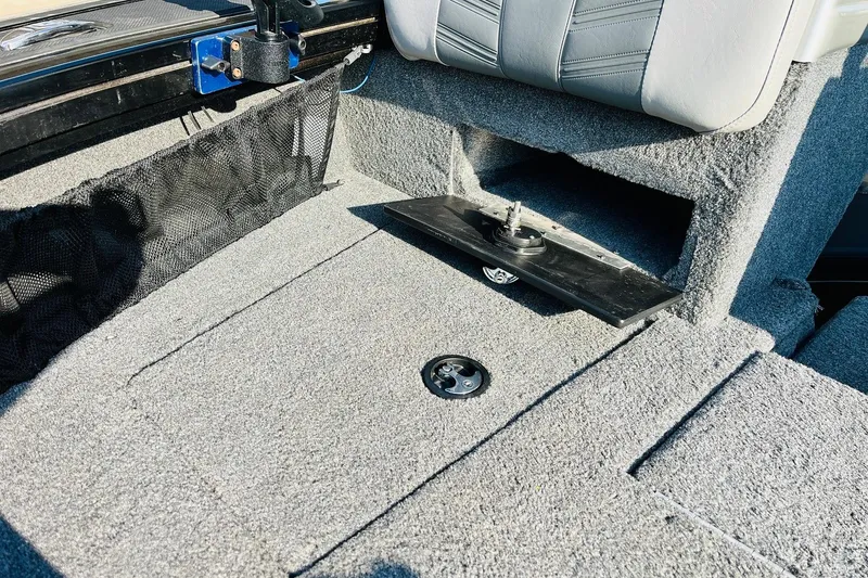 Slide: The Image of 2018 Tracker Targa V-19 Combo boat interior with carpeted flooring and storage compartment. - 24