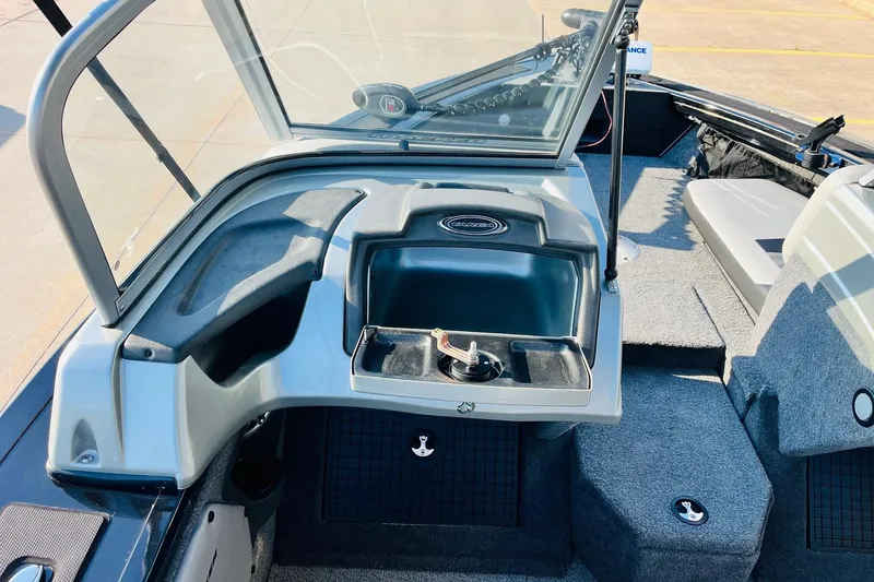Slide: The Image of 2018 Tracker Targa V-19 Combo boat interior with open windshield and storage compartments. - 28