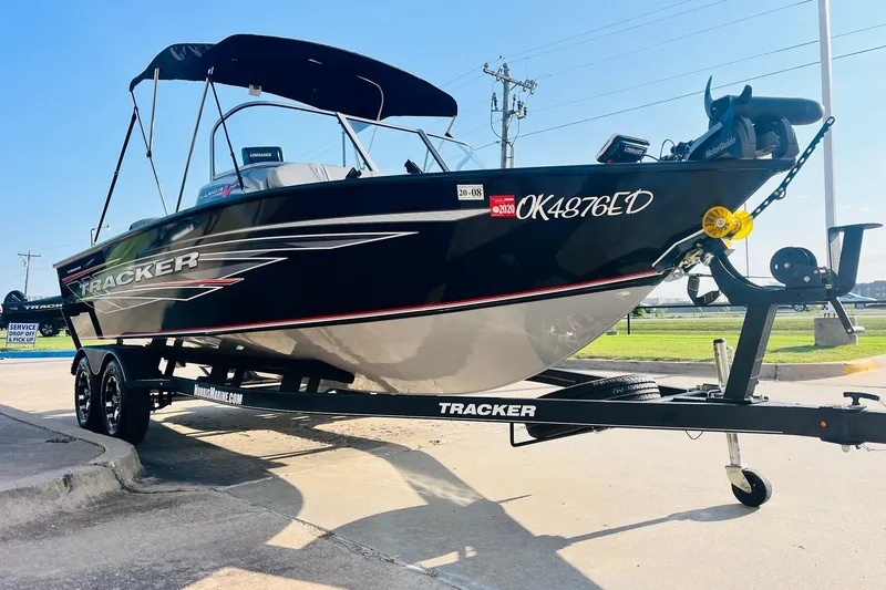 Slide: The Image of 2018 Tracker Targa V-19 Combo 40th Anniversary Edition boat on trailer, parked outdoors. - 3