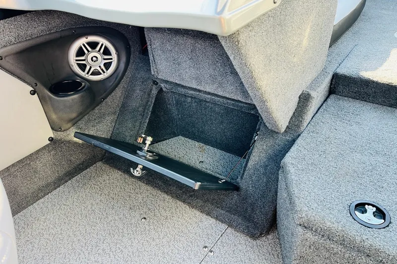 Slide: The Image of 2018 Tracker Targa V-19 Combo interior with speaker and storage compartment. - 30