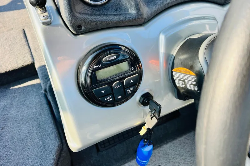 Slide: The Image of 2018 Tracker Targa V-19 Combo dashboard with control panel and ignition key. - 36
