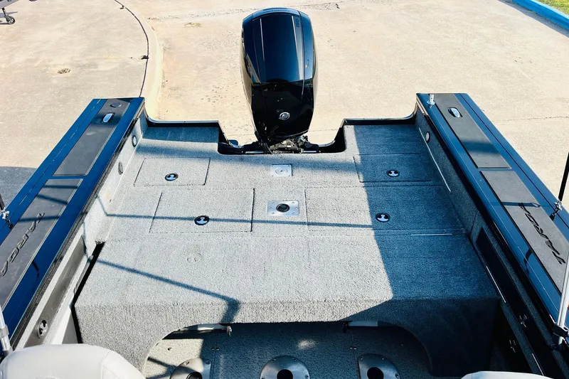 Slide: The Image of 2018 Tracker Targa V-19 Combo boat interior with motor, spacious deck, and storage compartments. - 40