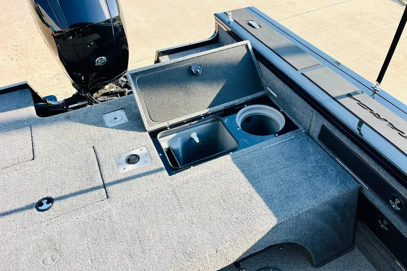 Slide: The Image of 2018 Tracker Targa V-19 Combo boat interior with storage compartments and motor. - 41