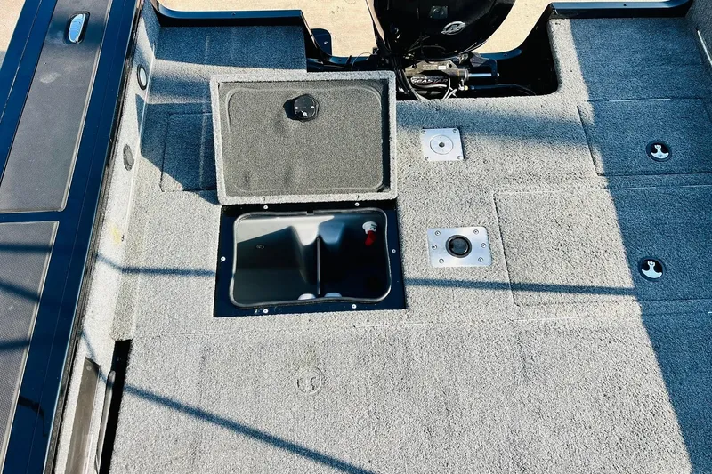 Slide: The Image of 2018 Tracker Targa V-19 Combo boat interior with open storage compartment. - 43