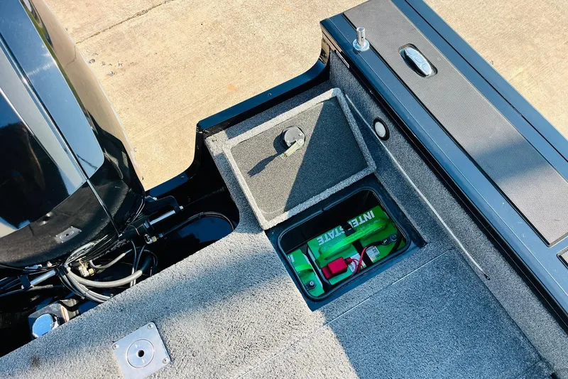 Slide: The Image of 2018 Tracker Targa V-19 Combo boat interior with battery compartment and engine details. - 46