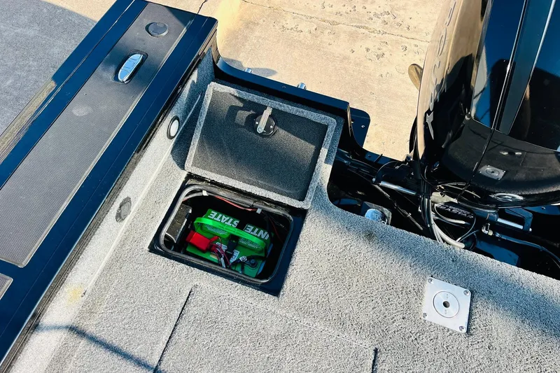 Slide: The Image of 2018 Tracker Targa V-19 Combo boat battery compartment with Interstate battery visible. - 47