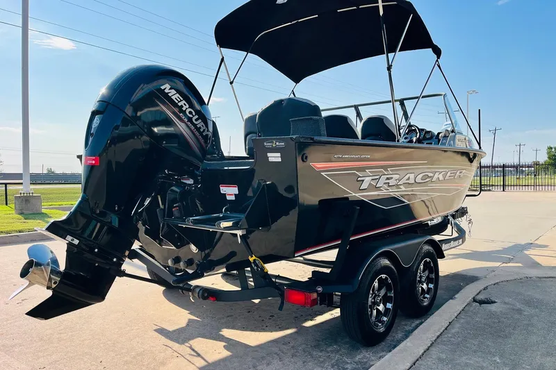 Slide: The Image of 2018 Tracker Targa V-19 Combo 40th Anniversary Edition boat with Mercury engine, parked outdoors. - 5