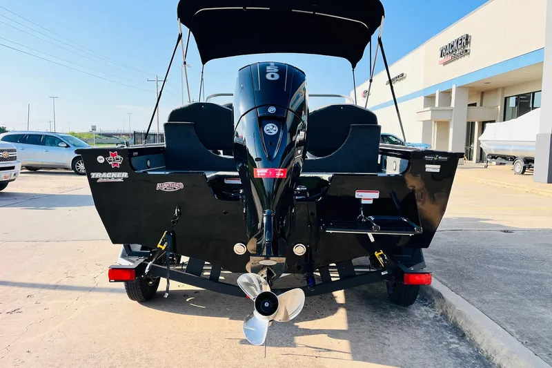 Slide: The Image of 2018 Tracker Targa V-19 Combo 40th Anniversary Edition boat, rear view with motor, outdoors. - 6