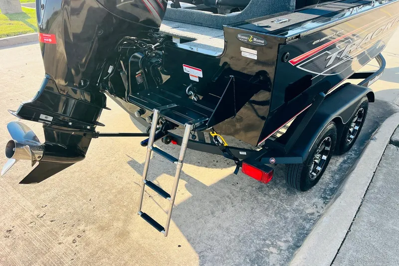 Slide: The Image of 2018 Tracker Targa V-19 Combo boat with outboard motor and ladder on trailer. - 8
