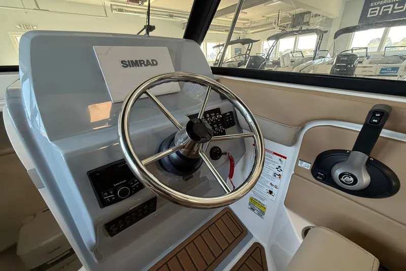 Slide: The Image of 2025 Bayliner Trophy T22SC helm with Simrad display and steering wheel. - 16